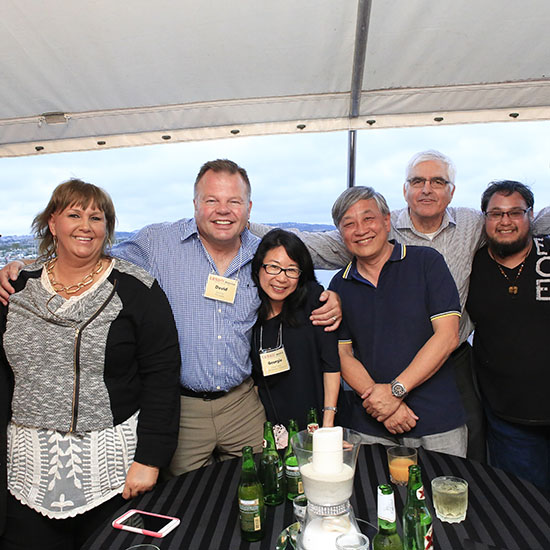 Group Posing on Yacht with Centerpiece Table Decor at Lesso Grand Opening in Corona, California
