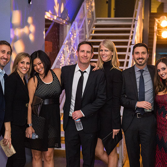Group Posing with GOBO Lighting in Background at Ziffren Law Holiday Party in Los Angeles