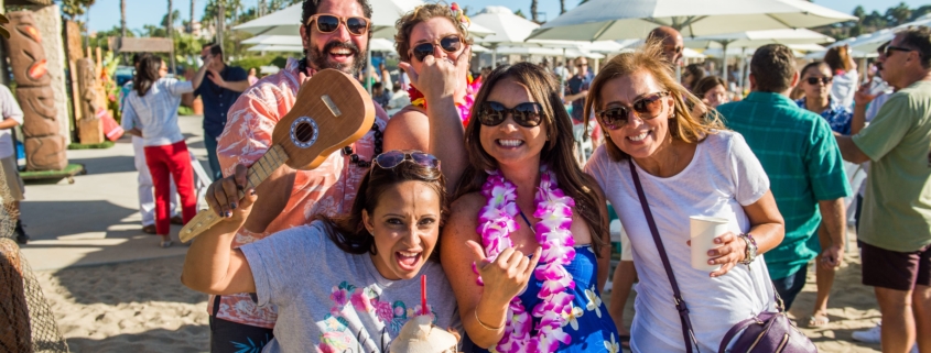 Guests at Company Luau at the Beach for Edwards Lifesciences with Branded Coconuts, Leis and Games