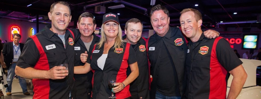 Group Photo of Employees with Custom Event Shirts at Ari Fleet Garage Party_311 Group Photo of Employees with Custom Event Shirts at Ari Fleet Garage Party_311