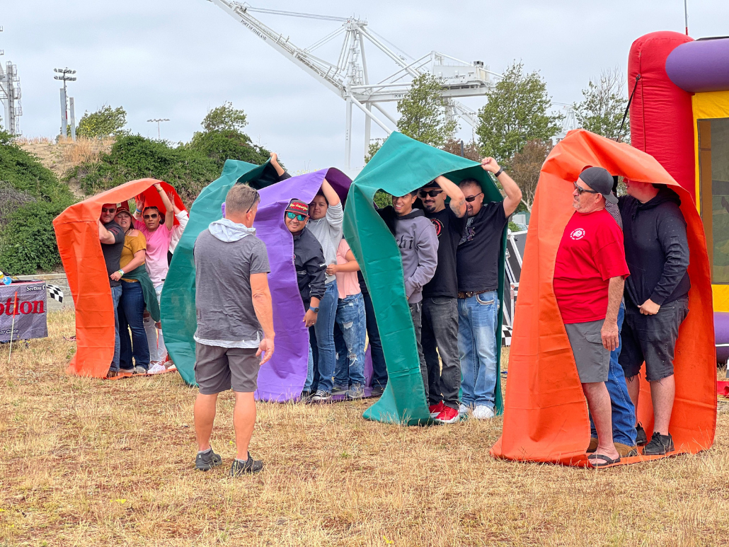 Staff Members Playing a Team Building Field Game at Dome Construction's Company Outing