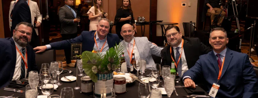 Group Sitting Around the Table at BEHR's 2024 Annual Sales Meeting
