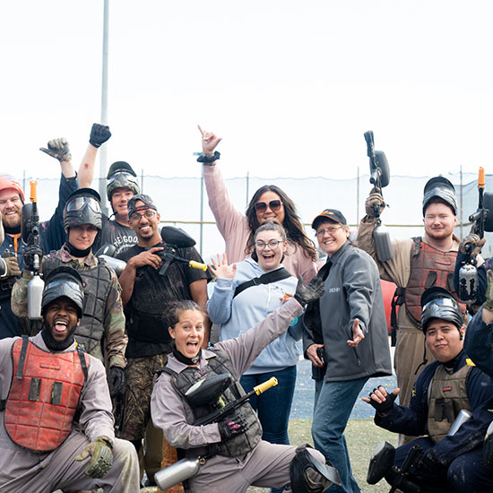 Team Posing for a Photo During Paintball Excursion at BEHR's 2024 Sales Meeting in Las Vegas