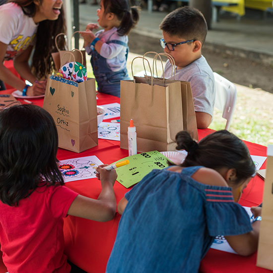 Kids at Arts & Crafts Station During AltaMed Día de Muertos Picnic in Los Angeles