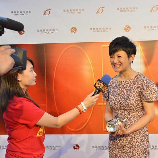 Staff Giving an Interview in Front of Branded Backdrop During Phoenix TV Anniversary Party in Los Angeles